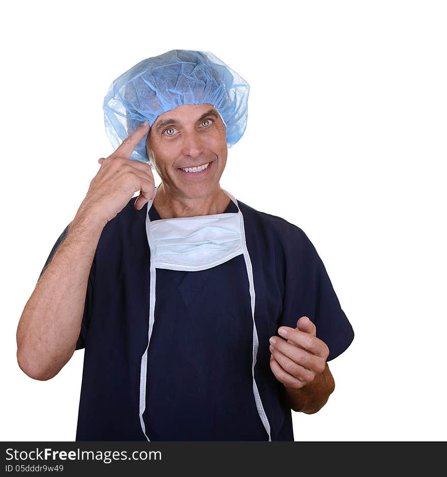 Smiling surgeon wearing navy blue scrubs, hair cover, and mask hanging down pointing at himself. Smiling surgeon wearing navy blue scrubs, hair cover, and mask hanging down pointing at himself