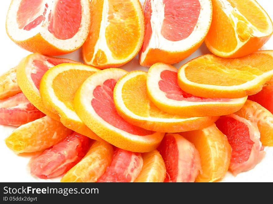 Grapefruit and oranges on a white background. Grapefruit and oranges on a white background