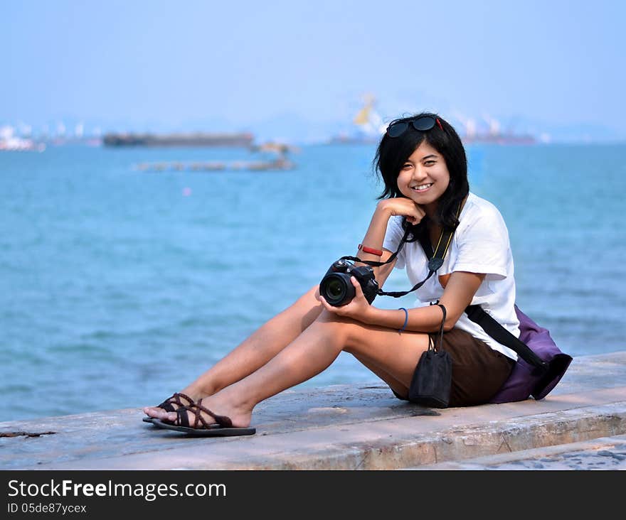 Young woman taking pictures on the beach