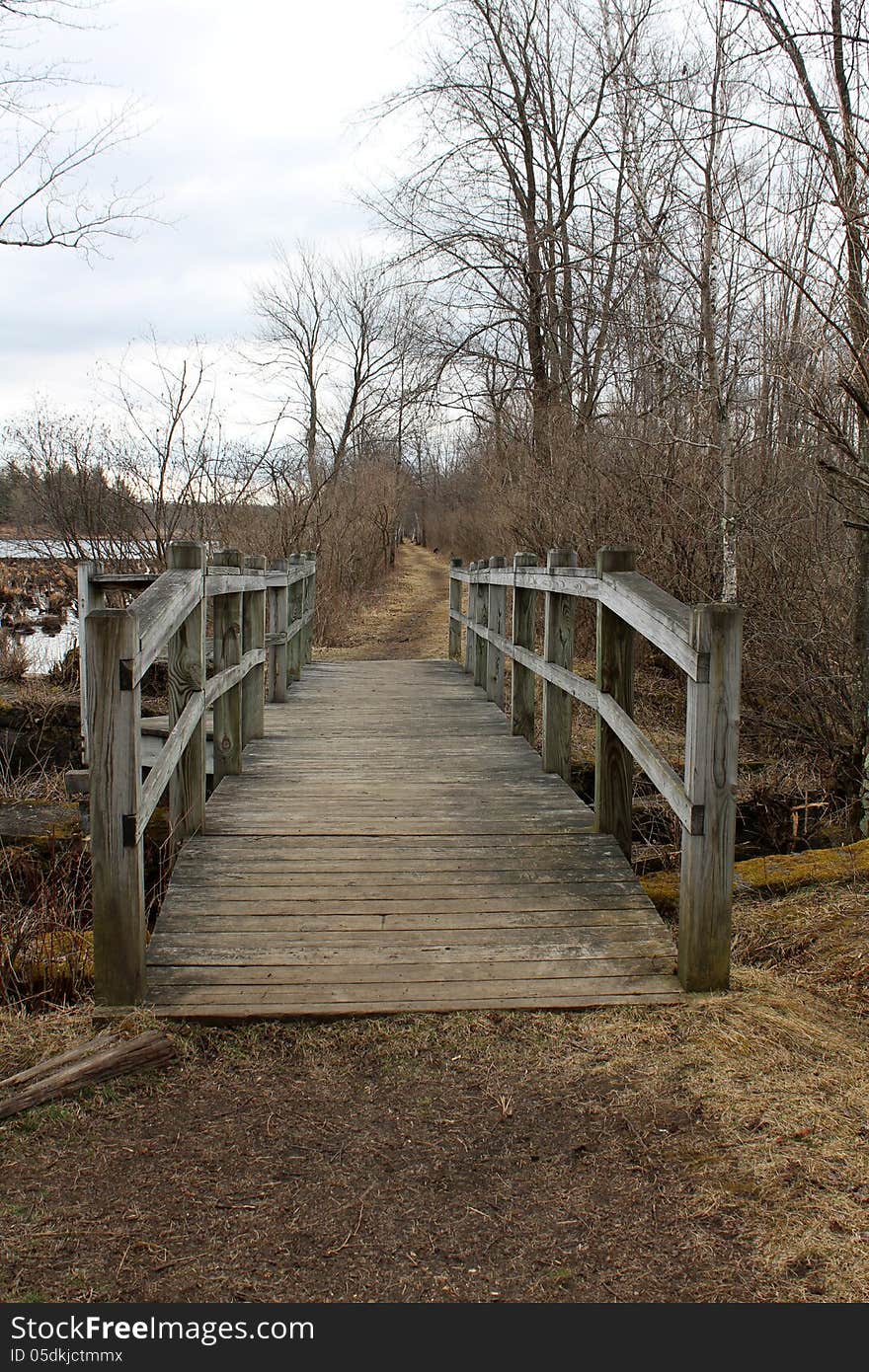 Old Wood Bridge Over Marsh Water