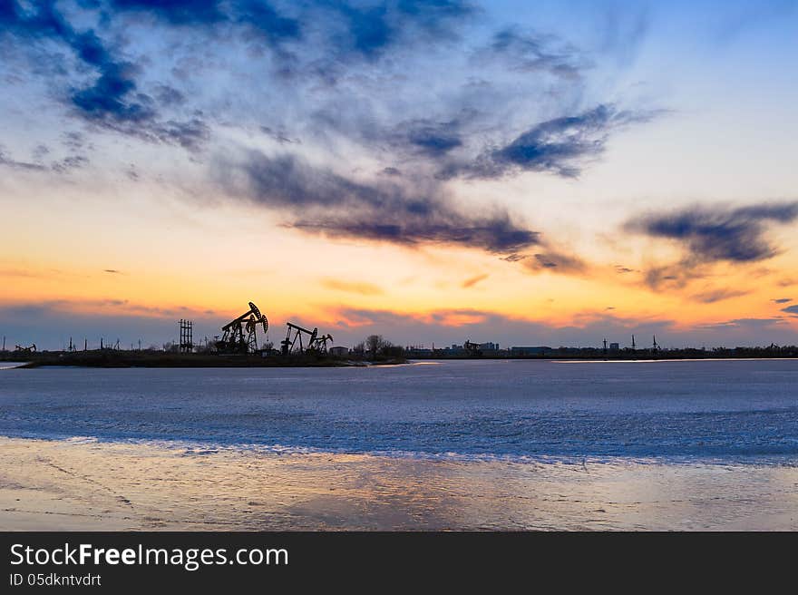 The oil pumping machine on ice lake