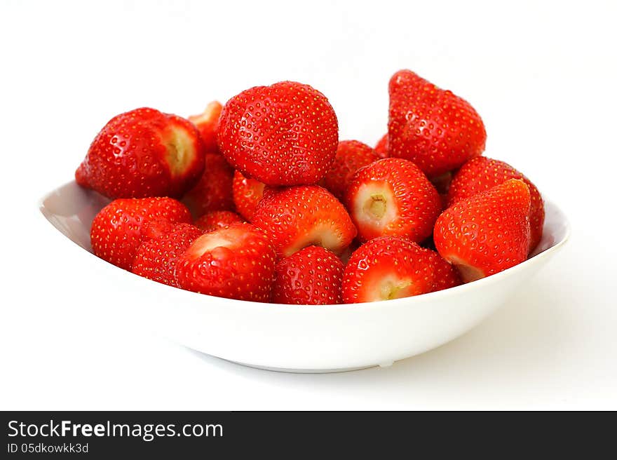 Fresh strawberries in a bowl on white background