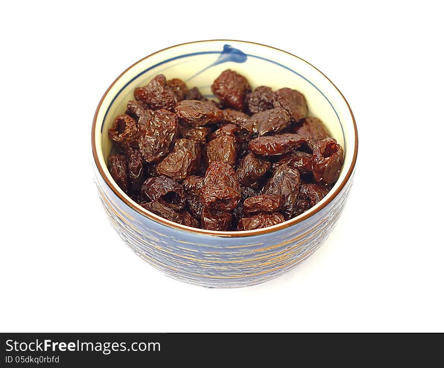 Dried olives in a bowl on a white background