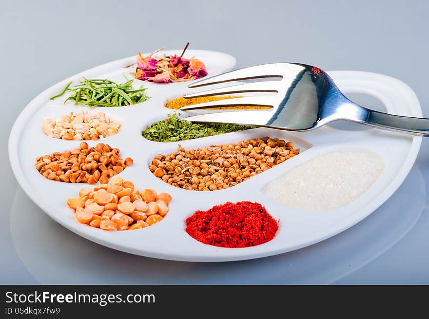 The palette of spices and groceries with a fork