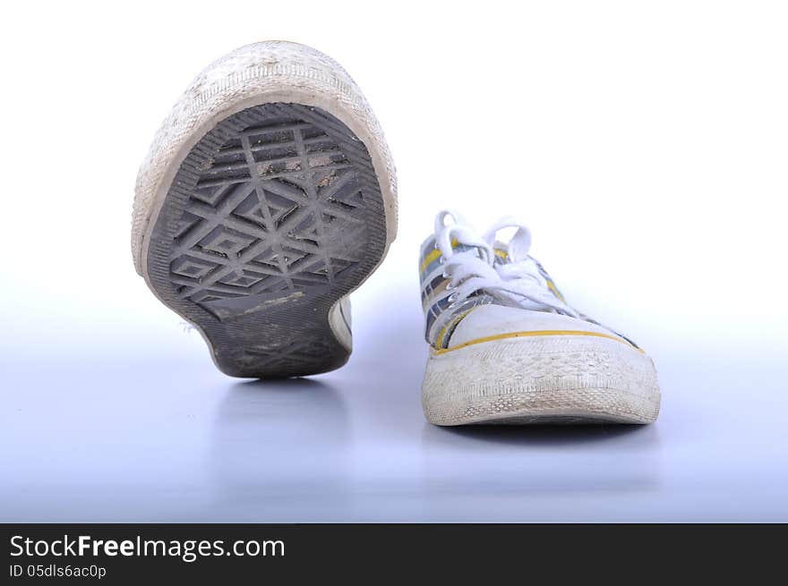 Dirty sneakers on white background