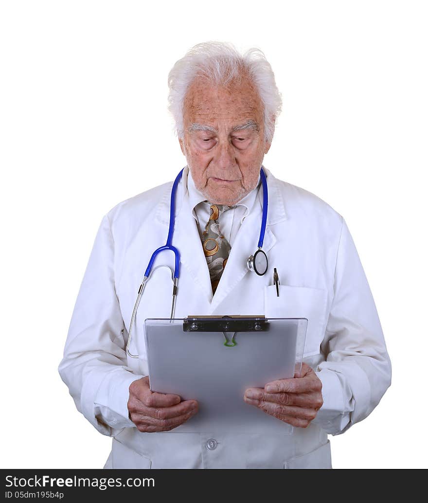 Senior doctor wearing a white lab coat and blue stethescope looking down at clip board. Senior doctor wearing a white lab coat and blue stethescope looking down at clip board