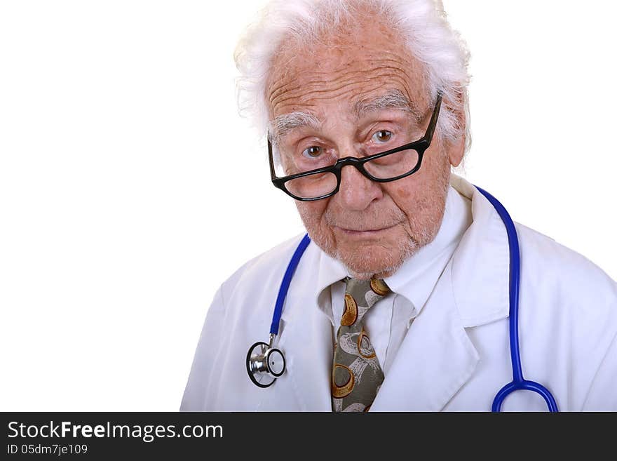 Senior doctor with gray hair wearing a white lab coat, glasses, and a blue stethoscope with kind look on his face isolated on white. Senior doctor with gray hair wearing a white lab coat, glasses, and a blue stethoscope with kind look on his face isolated on white