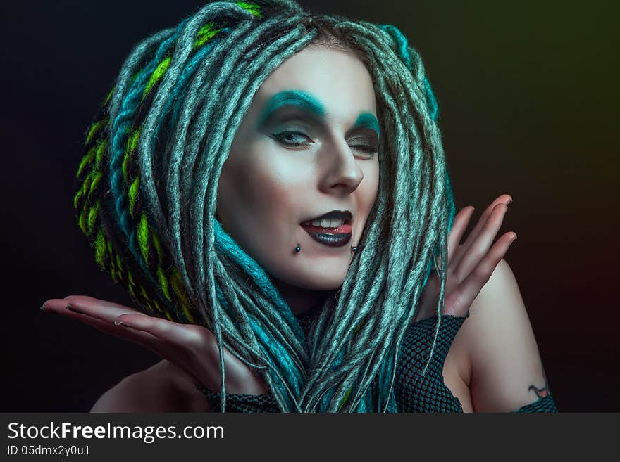 Pretty girl with dreadlocks posing in studio. Pretty girl with dreadlocks posing in studio