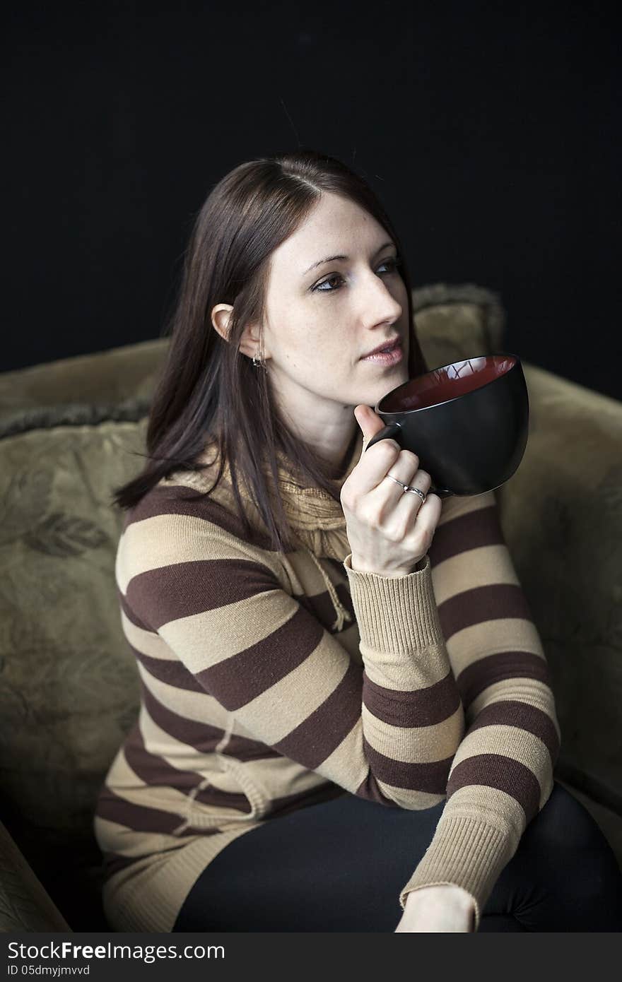 Beautiful Young Woman with Brown Hair and Eyes Holding Black Cof