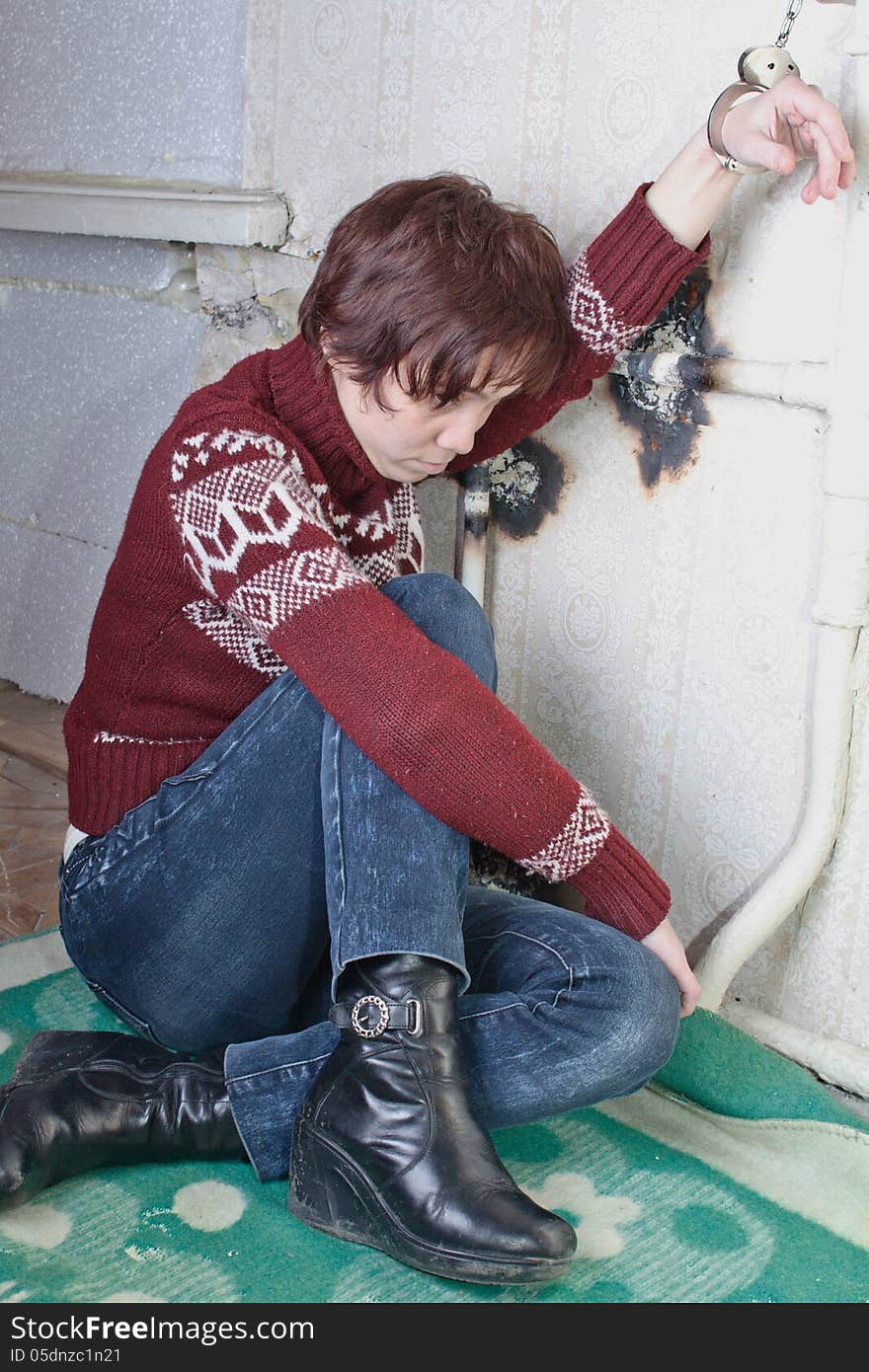 Girl a hostage is tied down handcuffs to the pipe. Girl a hostage is tied down handcuffs to the pipe