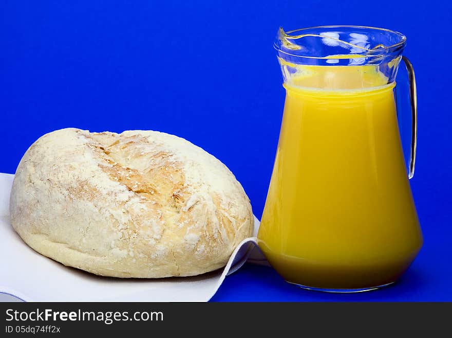 White homemade bread and a jug with orange juice. White homemade bread and a jug with orange juice