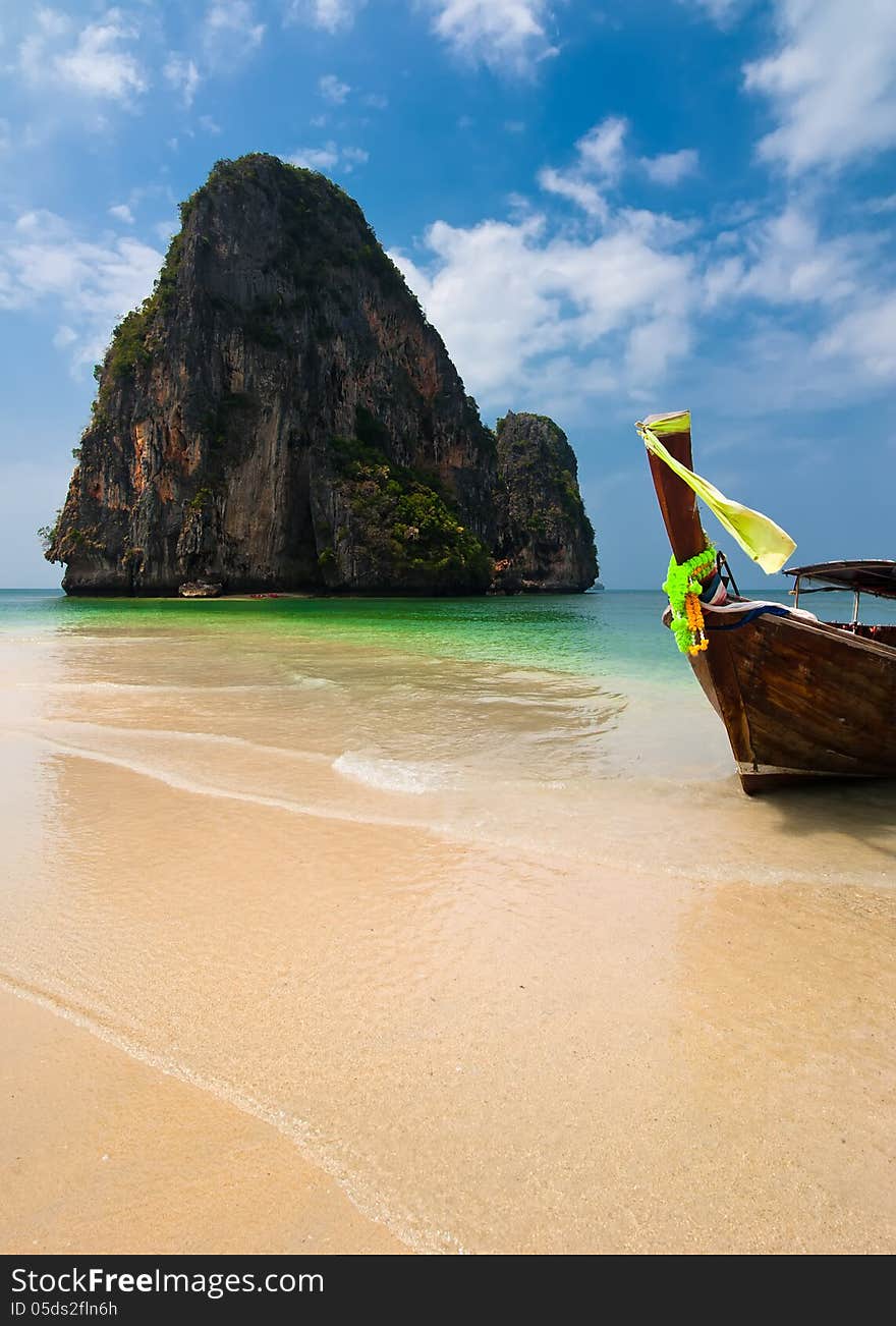 Tropical beach landscape. Thai traditional long tail boats at ocean gulf under blue sky. Pranang cave beach, Railay, Krabi, Thailand