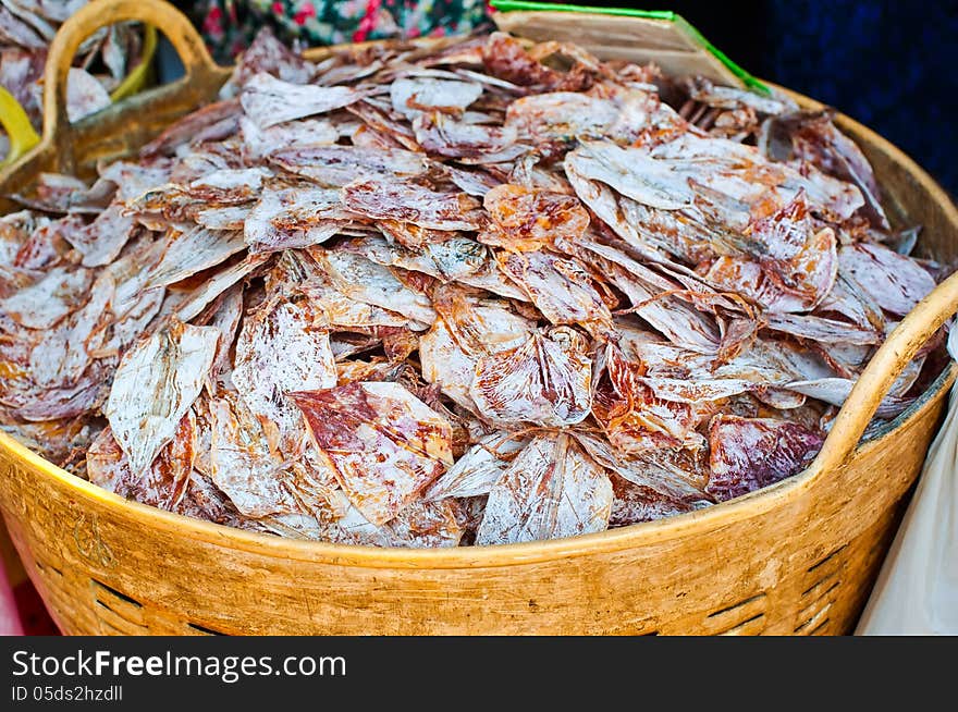 Sea food at market. Dry calamari