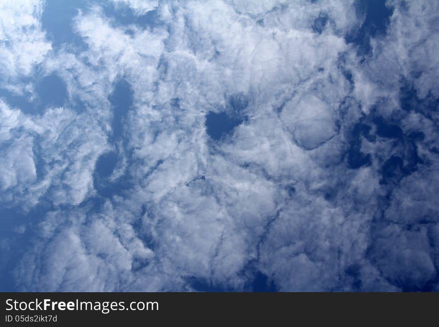 A lot of clouds in the blue skies during the day. A lot of clouds in the blue skies during the day