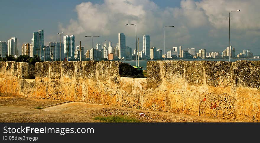 Contrast: High rising towers of Cartagena´s touristic peninsula Bocagrande seen from the old City Wall (XVI Century). Contrast: High rising towers of Cartagena´s touristic peninsula Bocagrande seen from the old City Wall (XVI Century).