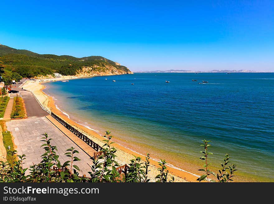 Dalian City, Liaoning Province, China.Wooden club island beach,blue sky,blue sea and golden sand.