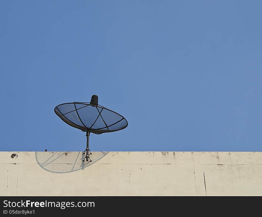 Satellite dish fix on top of building in sunlight. Satellite dish fix on top of building in sunlight