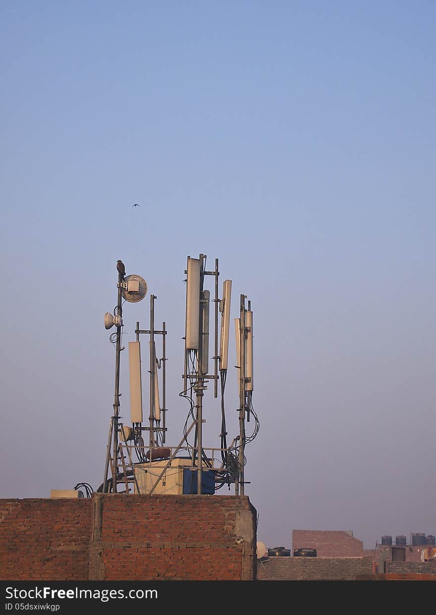 Set of antenna on top roof in sunlight