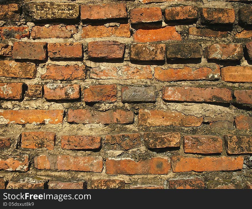 Pattern of old brick wall in sunlight