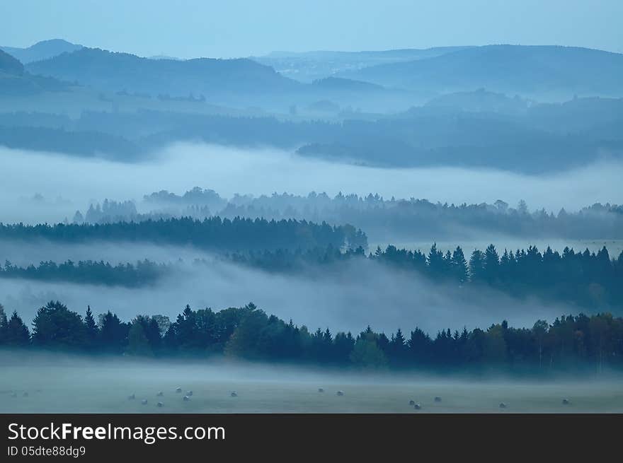 Autumn morning hilly landscape with fog