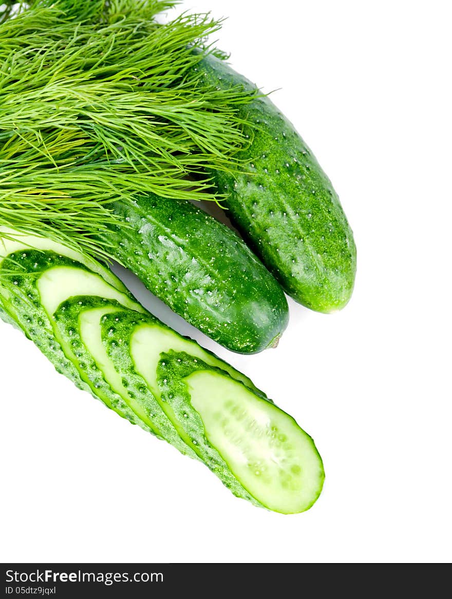 Slices of cucumber is with two cucumber and dill on a white background