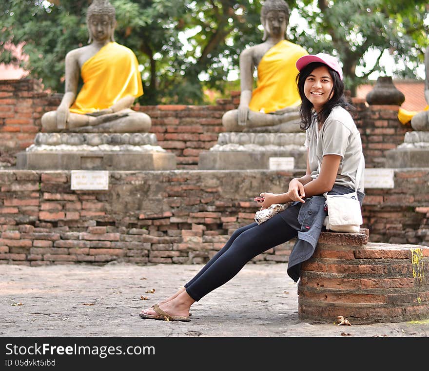 Beautiful young girl and buddha at Wat Yai Chai Mongkol Temple