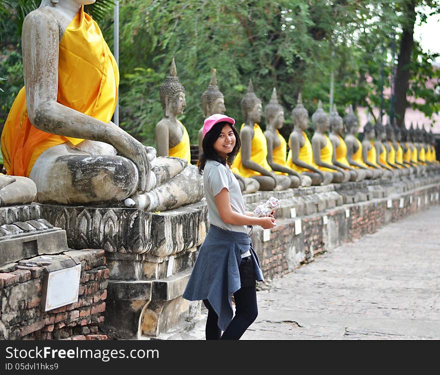 Beautiful asian woman and buddha at Wat Yai Chai Mongkol Temple