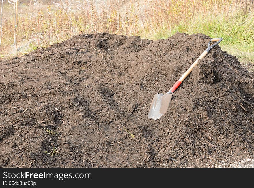 Pile of organic compost with shovel