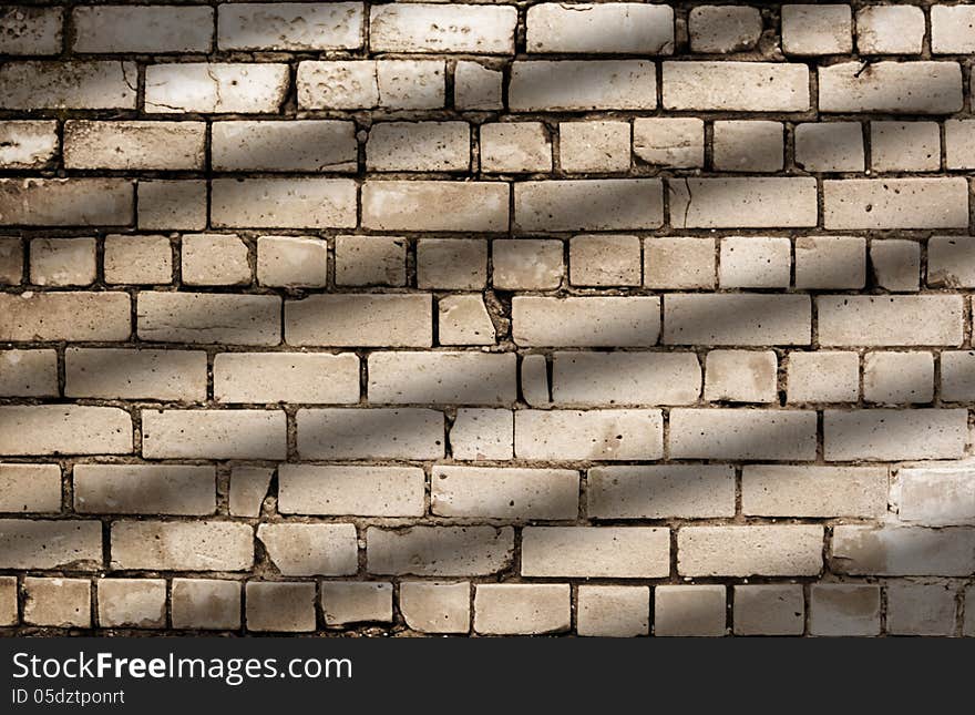 Diagonal lines shadow on the brick wall with fractures and cracks. Diagonal lines shadow on the brick wall with fractures and cracks.