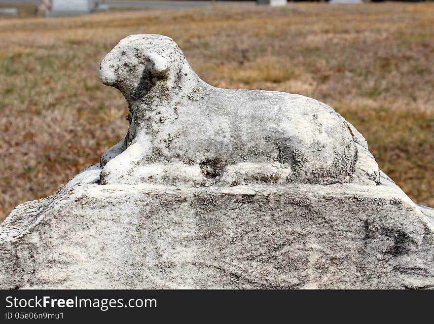 Stone statue of lamb on loved ones grave