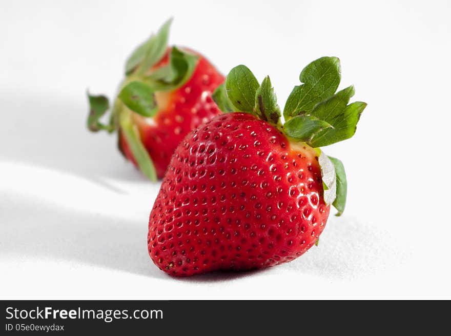 Two strawberries isolated on white background