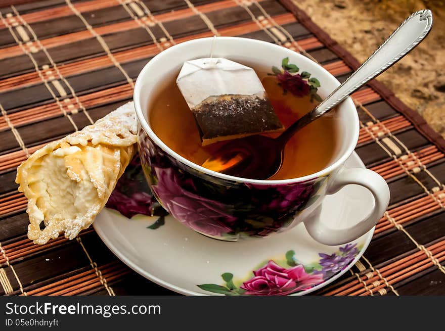 Cup of tea with pastry after dinner