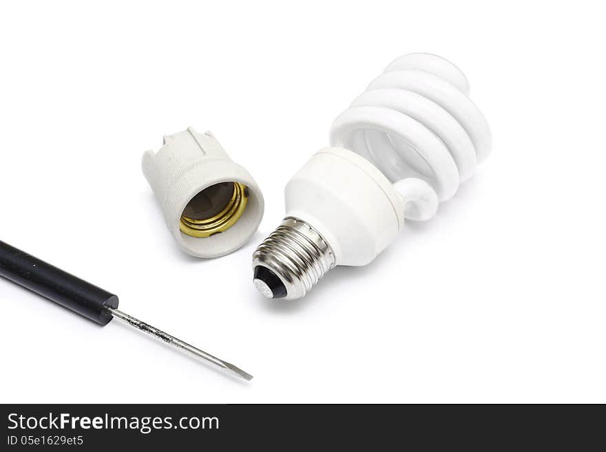 Compact florescent light bulb and screwdriver on white background