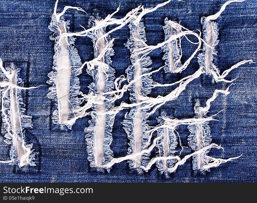 Creative embroidery on jeans, denim background. Creative embroidery on jeans, denim background