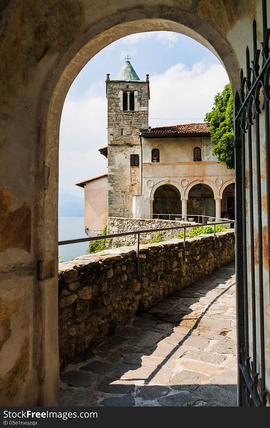 Monastery of Saint Catherine by Lake Maggiore, Leggiuno, Italy, seen through an archway. Monastery of Saint Catherine by Lake Maggiore, Leggiuno, Italy, seen through an archway.