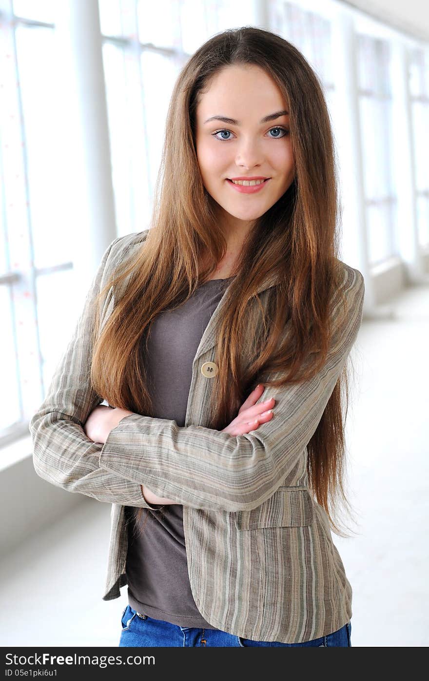 Young business girl with a folder in hands at office