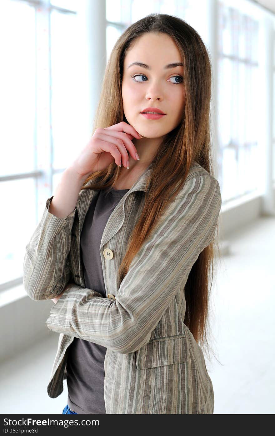 Young business girl with a folder in hands at office