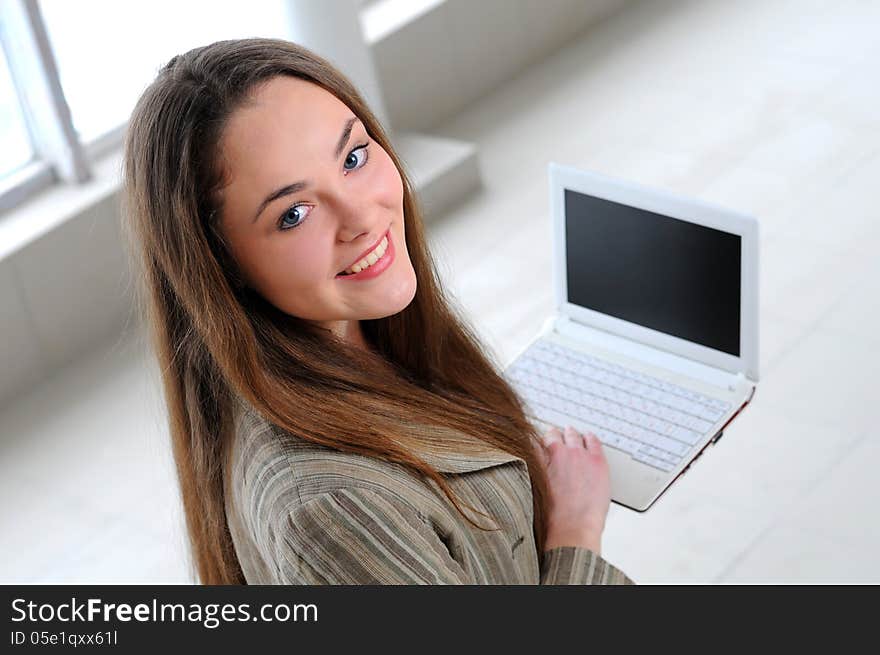 Young business girl with a notebook in hand in the office