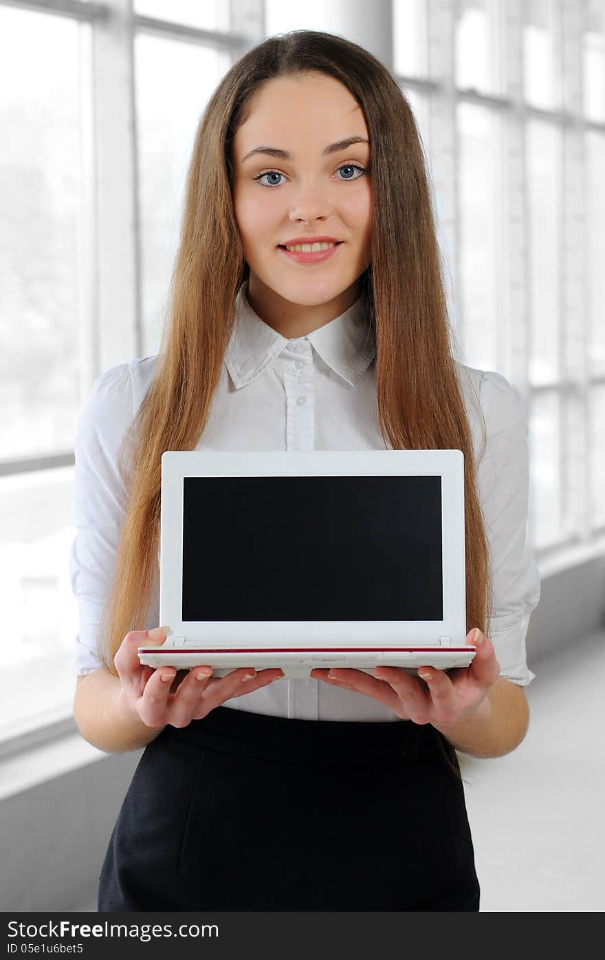 Young business girl with a notebook in hand in the office