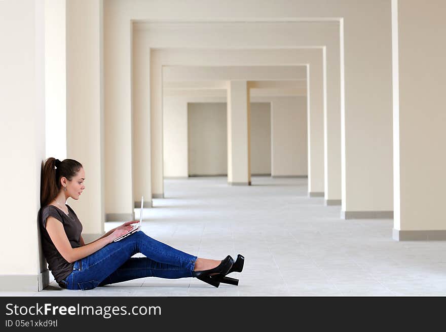 Young girl with laptop in the office