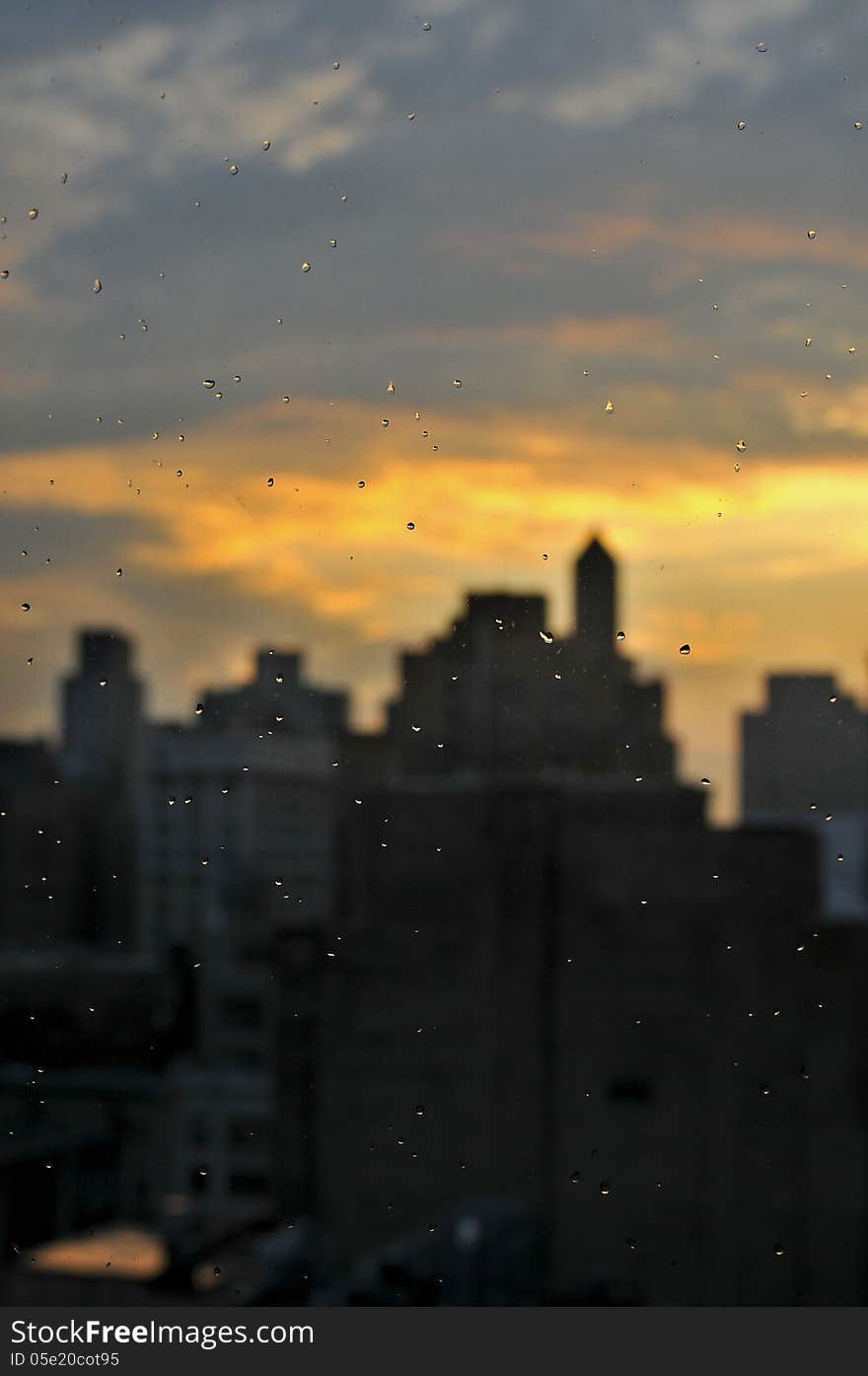 Rain Drops At Window With Unfocused Manhattan Skyline