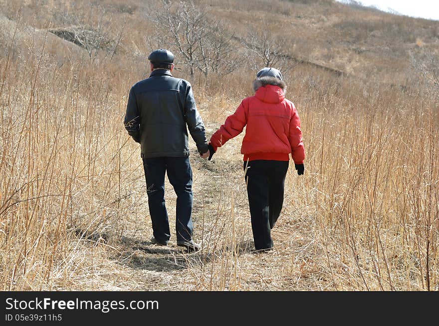 Man and women walking in the autumn field. Man and women walking in the autumn field