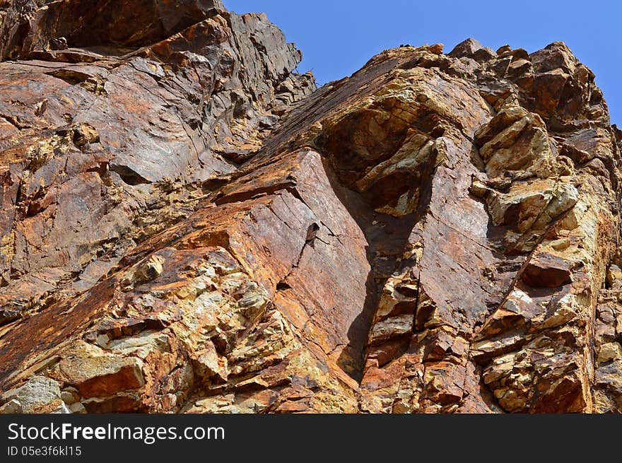 High dangerous rocks on the sky background. High dangerous rocks on the sky background