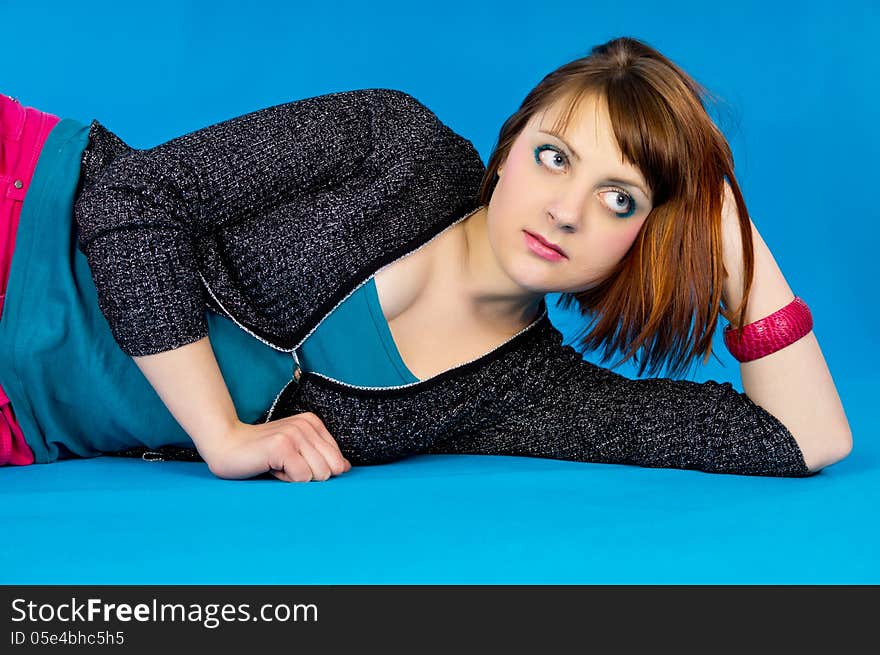 Portrait Redhead Girl On A Blue Background