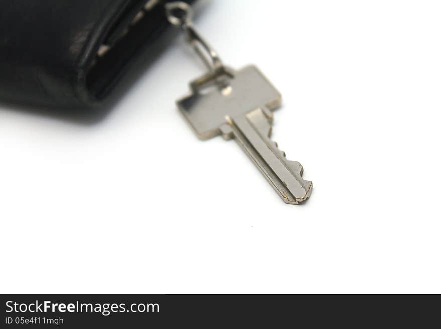 Single key on key fob over white background