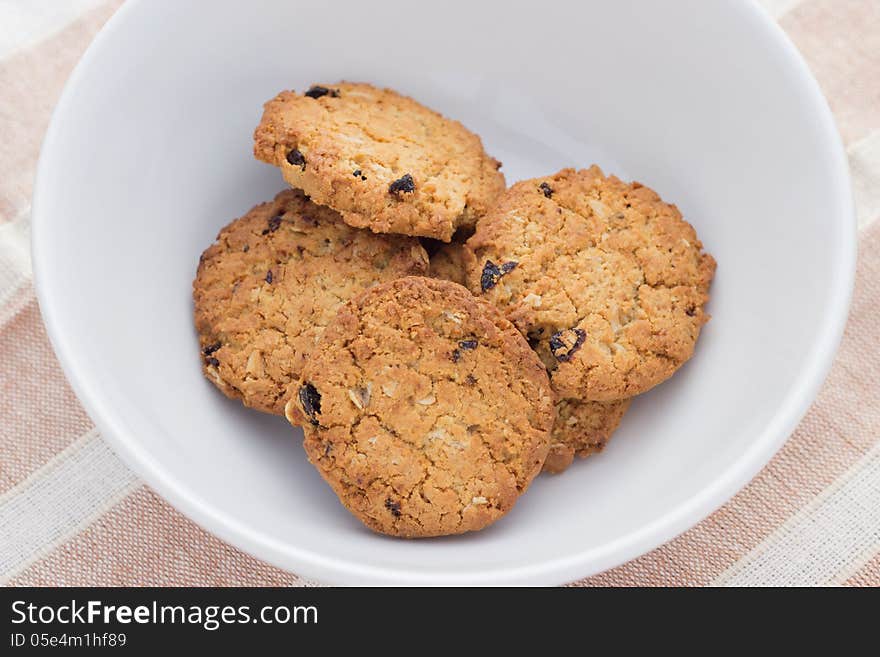 Home made chocolate chip cookies on a white plate