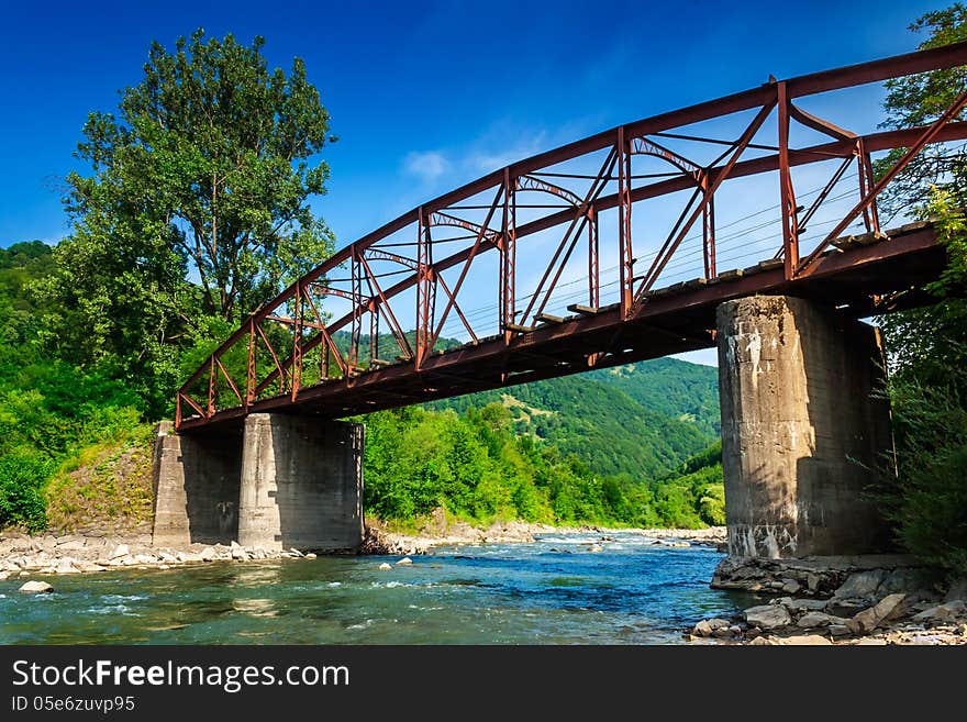 Old iron bridge over mountain river. Old iron bridge over mountain river