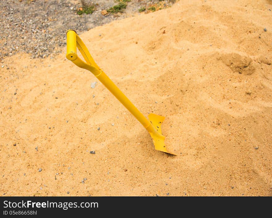 Yellow shovel in a sand. Yellow shovel in a sand.