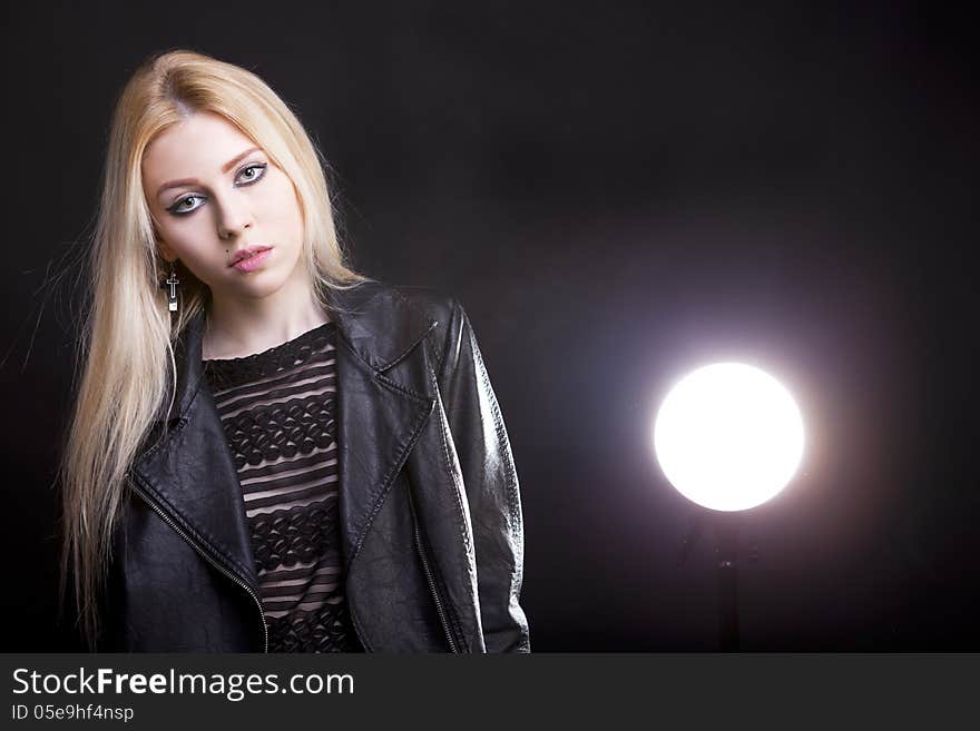 Gorgeous blonde with a light behind her and lans flare studio shot