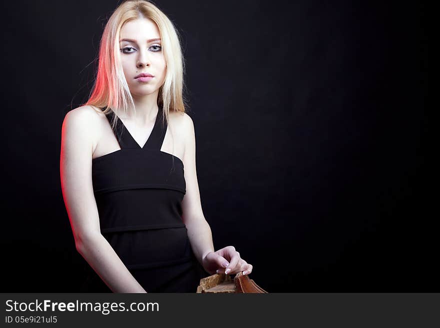 Attractive blonde model on a black background studio shot